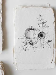 some white paper with flowers and pumpkins on it