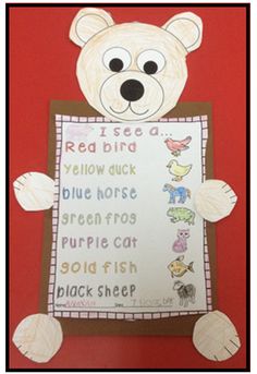 a paper cut out of a bear holding a sign that says, i see a red bird yellow duck blue horse purple frog gold fish black sheep