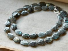 A show-stopping statement piece, our Nalani Necklace features beautifully cut, blue and green labradorite stones hand-strung onto a cotton cord. Necklaces Charms, Aqua Earrings, Detailed Necklace, Labradorite Necklace, Labradorite Necklaces, Labradorite Stone, Toggle Clasp, Cotton Cord, Body Oil