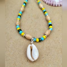 a necklace with a shell and beads on it