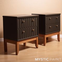 two black nightstands sitting on top of a hard wood floor next to each other