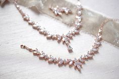 "The classic design of this radiant rose gold bridal necklace set is perfect for brides who truly want to shine! - Necklace measures 16\" - Earrings measure 1\" - Bracelet measures 6\" and extends to 8 inches - Handcrafted with high quality cubic zirconia - Available in rose gold, yellow gold and rhodium (silver) finish Browse My Entire Shop For More Jewelry & Accessories: https://www.etsy.com/shop/TheExquisiteBride Browse My Shop For Earrings: https://www.etsy.com/shop/TheExquisiteBride?sec Elegant Rose Gold Jewelry Sets For Formal Occasions, Formal Rose Gold Jewelry Sets With Elegant Design, Formal Rose Gold Elegant Jewelry Sets, Formal Elegant Rose Gold Jewelry Sets, Formal Bridal Necklace In Rose Gold With Elegant Design, Formal Rose Gold Bridal Necklace With Elegant Design, Rose Gold Delicate Bridal Necklace For Formal Occasions, Delicate Rose Gold Bridal Necklace For Formal Occasions, Elegant Rose Gold Jewelry For Mother Of The Bride