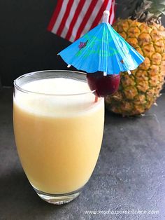 a pineapple drink in a glass with an umbrella