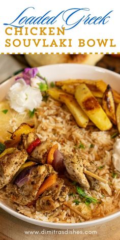 a bowl filled with chicken and rice next to some vegetables on top of a wooden table