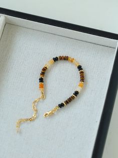 Elevate your style with a variety of natural stone beaded bracelets, including Tiger's Eye and Black Onyx, featuring an orange natural stone reminiscent of orange soda, adding a touch of coolness to hot summer days. This stunning piece perfectly combines Tiger's Eye with a variety of complementary beads to create a rich and vibrant accessory designed to highlight your personality and enhance your natural beauty. Metal: 18K Recycled Gold Plated On Brass Gemstone: Tiger's Eye/Multi Stone Length: 1 Adjustable Orange Gemstone Bead Bracelet, Adjustable Orange Natural Stone Beaded Bracelets, Adjustable Orange Beaded Bracelets With Natural Stones, Adjustable Orange Gemstone Bracelets, Adjustable Orange Crystal Bracelet With Natural Stones, Orange Agate Gemstone Bracelets, Elegant Orange Beaded Bracelet With Natural Stones, Orange Beaded Bracelet With Natural Stones, Amber Beaded Bracelets For Healing