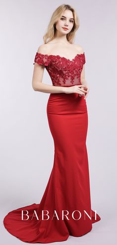 a woman in a long red dress with off the shoulder lace top and sleeves, posing for