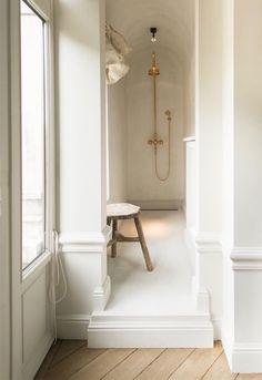 the interior of a house with white walls and wood floors