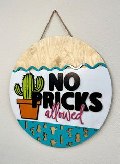 a sign that says no pricks allowed hangs on the wall in front of a white wall