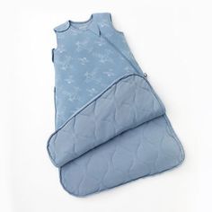 a baby sleeping bag with blue fabric and white stars on the top, laying down