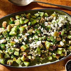 a salad with cucumbers, feta cheese and black pepper