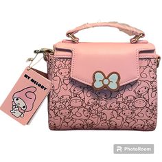 Loungefly Sanrio My Melody Allover Print Handbag My Melody’s Ready To Bring A Super Cute Touch To Your Style As The Allover Print Of This Loungefly Handbag! The Adorable Sanrio Rabbit Appears With Various Expressions As The Interior And Exterior Design Of This Accessory. With A Die-Cut Bow Applique On The Front Flap, This Handbag Also Features A Top Handle, Interior Pocket, And Removable Adjustable Crossbody Strap. Polyurethane; Polyester Lining Approx. 8" W X 6 1/2" H X 3 1/2" D Imported New Wi Cute Rectangular Leather Bag, Cute Rectangular Leather Shoulder Bag, Cute Leather Rectangular Shoulder Bag, Cute Top Handle Satchel For Shopping, Cute Shopping Bags With Top Handle, Cute Top Handle Shopping Bag, Cute Top Handle Travel Bags, Cute Top Handle Shoulder Bag For Travel, Cute Bag With Detachable Strap And Double Handle