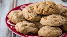 a red plate topped with cookies on top of a wooden table