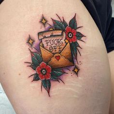 a woman's thigh with an envelope and flowers on it that says, tuck off