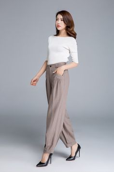 Summer Straight Pants With Button Cuffs, Spring Wide Leg Pants With Button Cuffs, Beige Linen Wide Leg Pants For Fall, Casual Straight Pants With Button Cuffs, Straight Linen Pants With Buttons, Beige Harem Pants For Work, High-waisted Linen Cargo Pants, Beige Harem Pants With Pockets For Work, Beige Loosely Fitted Harem Pants For Work