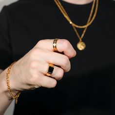 Our Black Onyx Gold Ring is made from Premium quality 316L stainless steel. This allows the ring to be water and sweat resistant. This Ring can be worn on its own as a statement or be layered with other rings and chains. The width of the ring is 9mm tapering to 3.25mm towards the back for maximum comfort.♛ DETAILS & MATERIALS ♛◈ Ring Sizes: 8, 9, 10 US◈ Ring Width: 9 MM tapering to 3.25mm at the back of the ring for comfort◈ Ring Style: Roman Numerals Gold Ring◈ Ring Quality: 316L stainless stee Minimalist Stainless Steel Jewelry With Black Enamel, Black Stainless Steel Ring Jewelry, Modern Stainless Steel Ring Jewelry, Modern Stainless Steel Ring, Black Stainless Steel Open Ring Jewelry, Stainless Steel Jewelry With Thick Band For Gifts, Modern Stainless Steel Metal Ring Jewelry, Minimalist Stainless Steel Chain Ring As Gift, Stainless Steel Rings With Adjustable Chain For Gift