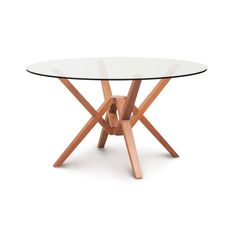 a round glass table with wooden legs