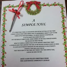 a simple nail poem with a christmas wreath on it and a pen laying next to it