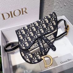 - Dior Oblique canvas- "D" accent at front flap- Antique gold finish metal- Removable black canvas belt with "CD" closure at front- Large interior compartment and 1 patch pocket- Can be as a belt, on shoulder, crossbody or as a clutchSize: 20 x 17 x 2.5 cm Brand Purses, Canvas Belt, Dior Oblique, Dior Saddle, Belt Pouch, Diaper Backpack, Black Canvas, Casual Backpack, Lady Dior