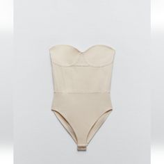 Knit Corset Style Bodysuit Elegant Seamless Beige Bodysuit, Elegant Beige Seamless Bodysuit, Elegant Summer Bodysuit With Built-in Bra, Chic Beige Lined Bodysuit, Elegant Spring Bodysuit With Built-in Bra, Chic Beige Bodysuit For Party, Spring Beige Lined Bodysuit, Elegant Beige Sleeveless Bodysuit, Chic Beige Party Bodysuit