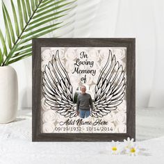 a memorial photo frame with an angel wings design