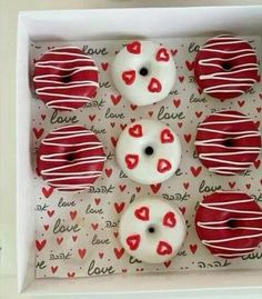 red and white donuts in a box with hearts on them