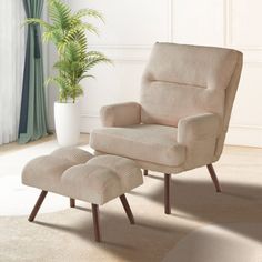 a chair and footstool in a room with a potted plant on the floor