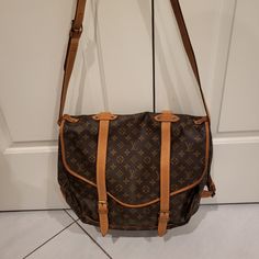 Authentic Louis Vuitton Saumur 43 In Good Used Condition. It Has Sign Of Wear And Watermark But No Cracks. It Is A Vintage Piece, About 31 Y/O. Interior Is Clean And No Foul Odor. Travel Shoulder Bag In Monogram Canvas With Flap, Travel Shoulder Bag With Monogram Canvas And Flap, Travel Monogram Canvas Shoulder Bag With Flap, Designer Monogram Canvas Flap Bag, Monogram Canvas Flap Satchel For Travel, Monogram Canvas Flap Satchel For Everyday Use, Everyday Monogram Canvas Flap Satchel, Louis Vuitton Saumur, Bags Louis Vuitton