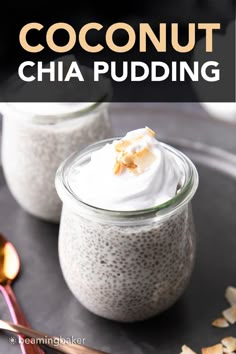 two jars filled with chia pudding sitting on top of a black plate next to spoons