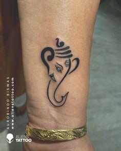 an elephant head tattoo on the ankle