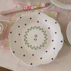 a table topped with plates and utensils on top of a cloth covered table