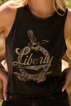 Mineral washed graphic tank top. Vintage-style "Liberty" text print with eagle and stars grpahics. Crew neckline. Sleeveless. Curved hem with lettuce-edge detailing. Racerback. Cropped length. Relaxed fit. 100% Cotton. Imported top designed and printed in LA. Text Print, Top Vintage, Graphic Tank, Lettuce, Graphic Tank Top, Crew Neckline, Vintage Style, Tops Designs, Vintage Fashion