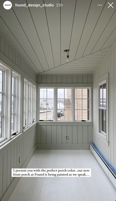 an empty room with white walls and wood paneling on the ceiling is shown in this image