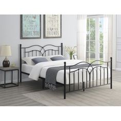 a black metal bed frame in a bedroom