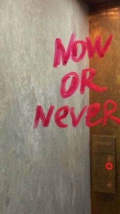 there is graffiti on the wall next to an elevator door that says now or never