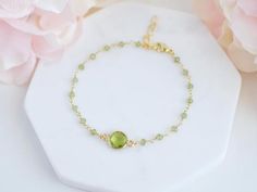 This peridot bracelet is the perfect gift for yourself or a loved one.Peridot is believed to bring good health, restful sleep, and peace to relationshipsPeridot is the birthstone for the month of August and makes a lovely birthday gift.-------------------------------ALL PERIDOT JEWELRYhttps://etsy.me/2YADXpQ-------------MATERIALThe Peridot stone is made via hydrothermal process and the tiny peridot stones are made with gold plated or sterling silver wire.Initial charm is made in stainless steel Green Gemstone Crystal Bracelet Gift, Green Round Chain Bracelet Gift, Green Chain Bracelet For May Birthstone Gift, May Birthstone Crystal Gemstone Bracelet, Green Round Birthstone Bracelet, Green Jubilee Bracelet Perfect As A Gift, Green Jubilee Bracelet As A Gift, Adjustable Peridot Bracelet, Adjustable Peridot Bracelets For Gifts