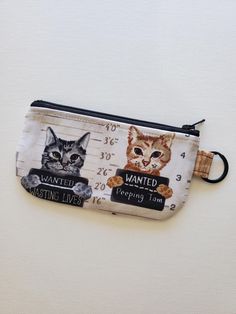 Lightly padded 5" wide X 3" long flat zipper pouch.  Perfect size for small items such as 6 hi-chews, a couple of lip balms & cough drops, or cards & coins. Outer layer:  Light weight cotton, bad kitties print. Inner layer:  Dashingaces' favorite wood grain print cotton, by Contempo Studios. With a 1" key ring. Pattern may slightly vary. Ring Pattern, Cough Drops, Flat Pouch, Bad Cats, Lip Balms, Small Items