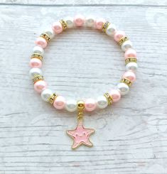 Cute starfish beaded stretch bracelet. Perfect gift for any animal lover for a birthday or a special gift. These are great gifts for little girls aswel as adults, you will find matching items in my store. *The bracelets are available for adults and children. Adults measure approximately 7.5inches unless a note is made. Children sizes vary depending on age of child. *The bracelets are made using 8mm glass pearl beads in any colours of your choice. which can be selected from the menu. *In between the beads are gold rhinestone beads to give a little sparkle.  *In the centre is a gold plated enamel starfish charm. *The charm measures approximately 2cms. ☆☆The bracelet comes presented in a little gift bag, I also have gift wrap and messages available to purchase from my store☆☆ If you have any Pink Starfish Jewelry For Gift, Pink Starfish Charm Jewelry, White Charm Bracelet With Star Charm As Gift, Starfish Charm Bracelet As Gift, Star-shaped Bracelet With Starfish Charm Gift, Adjustable Stretch Bracelet With Star Charm As Gift, Starfish Charm Bracelet As A Gift, Starfish Charm Bracelet Gift, Ocean-inspired Starfish Bracelets As Gifts