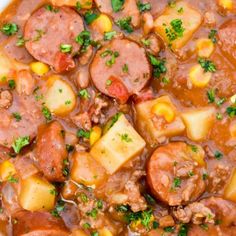 a white bowl filled with stew and potatoes on top of a wooden table next to a blue towel