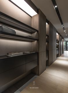 an empty room with wooden floors and shelves