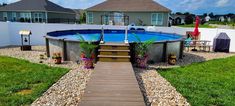 an above ground pool with steps leading up to it and a deck in the middle