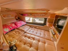 the inside of a camper with a bed and television