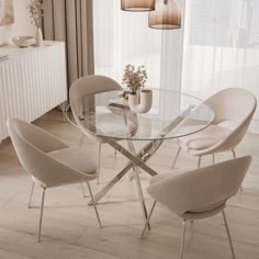 a glass dining table with white chairs around it