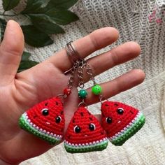 two pieces of watermelon are being held in the palm of someone's hand