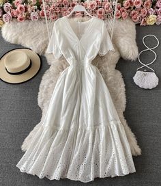 This elegant white eyelet lace midi dress is a timeless addition to any wardrobe, perfect for both casual and semi-formal occasions. The dress features a classic V-neckline and flutter sleeves, adding a touch of femininity and charm. The intricate eyelet lace detailing throughout the dress enhances its delicate and sophisticated appeal.The fitted bodice transitions into a beautifully flared skirt that falls to mid-calf length, offering a graceful and flattering silhouette. The waistline is subtl Summer V-neck Lace Dress With Ruffles, Chic V-neck Eyelet Dress, Fitted V-neck Eyelet Dress, Elegant Summer V-neck Dress With Flutter Sleeves, Elegant Midi Length Eyelet Dress, Chic Eyelet Midi Dress, White V-neck Dress With Lace Trim, Chic Eyelet V-neck Dress, V-neck Hollow Out Maxi Dress For Spring