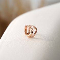 Inspired by our popular Amor and Amos rings, the design of our Linea Ear Cuff features two twisting bands that flow in parallel with one another. The delicate scale of this design invokes a quiet beauty for a modern effortless look. Dimensions: 0.6" diameter x 0.3" width Available in: Sterling Silver, 18K Rose Gold Vermeil Includes: One ear cuff and a custom felt pouch Modern Rose Gold Open Band Jewelry, Adjustable Twisted Modern Jewelry, Elegant Rose Gold Ear Cuff For Everyday, Modern Adjustable Twisted Jewelry, Modern Hypoallergenic Open Band Jewelry, Elegant Open Ring Ear Cuff For Everyday, Jewelry Roll Travel, Quiet Beauty, Felt Pouch