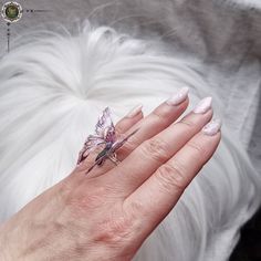 **Purple Fairy Wings Ring** Step into a realm of enchantment with our Adjustable Purple Fairy Wings Ring. This mesmerizing piece of jewelry is meticulously handcrafted to bring a touch of magic and whimsy to your fingertips. **Key Features - Exquisite Design: The ring features exquisite fairy wings made of shimmering purple resin. The translucent nature of the resin adds a captivating depth to the wings, evoking a sense of wonder and fantasy. The delicate details and graceful curves of the wings Magical Crystal Ring Gift, Purple Fairycore Jewelry For Gifts, Fairycore Purple Jewelry As A Gift, Purple Fairycore Jewelry For Jewelry Making, Handmade Magical Crystal Ring As Gift, Handmade Purple Fairycore Jewelry, Handmade Magical Crystal Ring For Gift, Handmade Pink Fairy Jewelry, Whimsical Purple Jewelry For Gifts