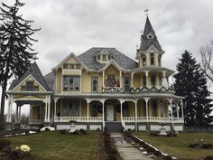 a large yellow house with a clock tower