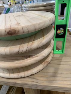 a stack of wooden boards sitting on top of a table next to a knife holder