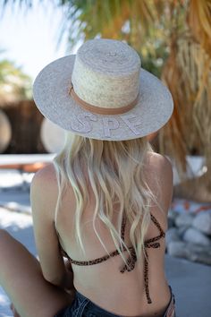 Handmade by artisans in Mexico, our new 100% baked palm leaf SPF Straw Hat is perfect for spring and summer wear. Featuring a molded crown and tightly woven pressed palm, this hat offers the most sun protection. Embellished with a faux suede band and crystal lettering. Available in the rancher or boater style straw hat. Boater - flat crown style Rancher - pointed crown style - Hat is not adjustable, has an elastic band on the inside. If you think you’ll need a tighter fit or have a smaller head, Adjustable Straw Sun Hat With Structured Crown, Adjustable Toquilla Straw Sun Hat With Structured Crown, Adjustable Structured Crown Straw Hat For Vacation, Adjustable Straw Panama Hat With Structured Crown, Vacation Straw Hat With Structured Crown, Vacation Hat With Structured Crown, Adjustable Sun Hat With Structured Crown For Vacation, Adjustable Structured Crown Sun Hat For Vacation, Natural Straw Hat With Structured Crown