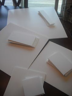 several pieces of white paper sitting on top of a table